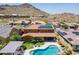 Spacious backyard with pool, outdoor kitchen, well-maintained landscaping, and mountain views at 27809 N Silverado Ranch Rd, Peoria, AZ 85383
