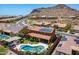 Aerial view of backyard with pool, spa, outdoor kitchen, and mountain views in a desirable neighborhood at 27809 N Silverado Ranch Rd, Peoria, AZ 85383