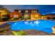 Picturesque backyard with sparkling pool, landscaped surroundings, covered patio and expansive lawn at 27809 N Silverado Ranch Rd, Peoria, AZ 85383