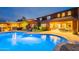Beautifully landscaped backyard showcasing a refreshing pool, cozy seating, and outdoor dining area at 27809 N Silverado Ranch Rd, Peoria, AZ 85383