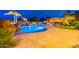 Stunning backyard with custom pool, rock waterfall feature, outdoor kitchen, and comfortable lounge area at 27809 N Silverado Ranch Rd, Peoria, AZ 85383