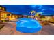 Amazing outdoor space with lagoon-style pool, rock waterfall, mature palm trees, and lush greenery at 27809 N Silverado Ranch Rd, Peoria, AZ 85383