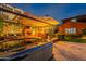 Beautiful backyard with a hot tub, outdoor kitchen, fireplace, and comfortable seating area under a pergola at 27809 N Silverado Ranch Rd, Peoria, AZ 85383