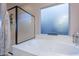 Bathroom featuring a separate bathtub and shower, a large window, and modern fixtures at 27809 N Silverado Ranch Rd, Peoria, AZ 85383