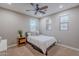 Bedroom with a ceiling fan, neutral walls, and window with blinds for natural light at 27809 N Silverado Ranch Rd, Peoria, AZ 85383