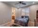 Bedroom includes a ceiling fan and window with a view to the bathroom at 27809 N Silverado Ranch Rd, Peoria, AZ 85383