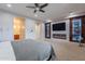 Spacious bedroom with an en-suite bathroom featuring a fireplace and TV with built in shelving with accent lighting at 27809 N Silverado Ranch Rd, Peoria, AZ 85383