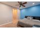 Bright bedroom with blue accent wall, fan, and carpet floor at 27809 N Silverado Ranch Rd, Peoria, AZ 85383