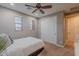 Bedroom boasts a ceiling fan, window views, and closet doors for a comfortable space at 27809 N Silverado Ranch Rd, Peoria, AZ 85383