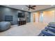 Large bonus room with big windows, theater chairs, ceiling fan, and game storage at 27809 N Silverado Ranch Rd, Peoria, AZ 85383