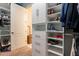 Spacious walk-in closet with custom shelving and storage for shoes, clothes, and accessories at 27809 N Silverado Ranch Rd, Peoria, AZ 85383