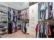 Walk-in closet with custom shelving and storage solutions for optimal organization at 27809 N Silverado Ranch Rd, Peoria, AZ 85383