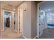 Hallway with many rooms featuring neutral colors and carpet flooring at 27809 N Silverado Ranch Rd, Peoria, AZ 85383