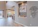 Hallway showcasing stylish decor, a decorative wall niche, and seamless flow into the kitchen and backyard at 27809 N Silverado Ranch Rd, Peoria, AZ 85383