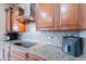 Stylish kitchen featuring stainless steel appliances, granite countertops, and mosaic backsplash at 27809 N Silverado Ranch Rd, Peoria, AZ 85383