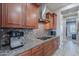 Modern kitchen featuring granite countertops, mosaic backsplash, stainless steel hood, and sleek dark wood cabinets at 27809 N Silverado Ranch Rd, Peoria, AZ 85383