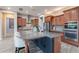 Updated kitchen with a large center island, stainless steel appliances, and custom cabinets at 27809 N Silverado Ranch Rd, Peoria, AZ 85383