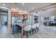Open concept kitchen featuring a large island, breakfast bar, and stainless steel appliances at 27809 N Silverado Ranch Rd, Peoria, AZ 85383