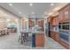Spacious kitchen boasts wood cabinets, granite counters, an oversized island with seating, and stainless steel appliances at 27809 N Silverado Ranch Rd, Peoria, AZ 85383