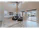 Spacious living room featuring sliding glass doors with access to a beautiful outdoor pool at 27809 N Silverado Ranch Rd, Peoria, AZ 85383