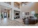 Spacious living room boasts soaring ceilings, wood accent walls, and comfortable leather furniture at 27809 N Silverado Ranch Rd, Peoria, AZ 85383