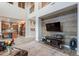 Bright living room with a two-story ceiling, wood-look accent wall, and open floorplan at 27809 N Silverado Ranch Rd, Peoria, AZ 85383