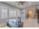Well-lit office space with plantation shutters, a sleek desk setup, and seamless connectivity to other areas at 27809 N Silverado Ranch Rd, Peoria, AZ 85383