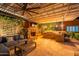 Charming outdoor living space with fireplace, ceiling fan, built-in grill, and comfortable seating at 27809 N Silverado Ranch Rd, Peoria, AZ 85383