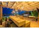 Inviting outdoor kitchen with built-in grill, bar seating, and stylish lighting under a pergola at 27809 N Silverado Ranch Rd, Peoria, AZ 85383