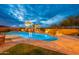 Inviting pool with a rock waterfall and lush landscaping, perfect for relaxation and entertainment at 27809 N Silverado Ranch Rd, Peoria, AZ 85383