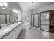 Bathroom with dual sinks, a tub, a glass enclosed shower, and modern lighting at 28897 N 94Th Pl, Scottsdale, AZ 85262