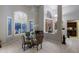 Elegant dining room with a glass table, high ceilings, and plenty of natural light at 28897 N 94Th Pl, Scottsdale, AZ 85262