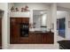 Kitchen with dark wood cabinets, granite countertops, and a view into a living space at 28897 N 94Th Pl, Scottsdale, AZ 85262