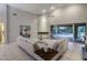 Cozy living room featuring a fireplace, neutral tones, and sliding glass doors to the outside patio at 28897 N 94Th Pl, Scottsdale, AZ 85262