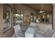 Covered patio with chairs and coffee table overlooking indoor living spaces at 28897 N 94Th Pl, Scottsdale, AZ 85262