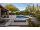 Inviting pool and hot tub area surrounded by desert landscaping and mature trees in this backyard at 28897 N 94Th Pl, Scottsdale, AZ 85262