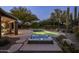 Inviting pool and hot tub area surrounded by desert landscaping and mature trees in this backyard at 28897 N 94Th Pl, Scottsdale, AZ 85262