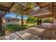 Covered patio and backyard with lush landscaping and storage shed at 3030 E Shangri La Rd, Phoenix, AZ 85028