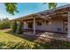 Lush backyard featuring a covered patio, providing an inviting outdoor space for relaxation and entertainment at 3030 E Shangri La Rd, Phoenix, AZ 85028