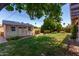 Backyard with storage shed, lush landscaping, and green grass at 3030 E Shangri La Rd, Phoenix, AZ 85028