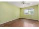 Bright bedroom features a ceiling fan, a large window providing ample natural light and warm green walls at 3030 E Shangri La Rd, Phoenix, AZ 85028