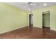 Spacious bedroom with bright green walls, ceiling fan, and a walk-in closet with easy access to the door at 3030 E Shangri La Rd, Phoenix, AZ 85028