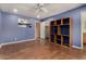 Spacious blue bedroom features built-in shelves, a ceiling fan, and easy access to closet and bath at 3030 E Shangri La Rd, Phoenix, AZ 85028