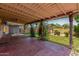 Spacious covered patio with a brick floor, providing an excellent space for outdoor dining and relaxation at 3030 E Shangri La Rd, Phoenix, AZ 85028