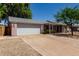 Single Gathering home with a 2-car garage and mature trees in the front yard at 3030 E Shangri La Rd, Phoenix, AZ 85028