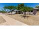 Charming home featuring low-maintenance landscaping and mature trees in the front yard at 3030 E Shangri La Rd, Phoenix, AZ 85028