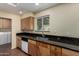Updated kitchen with black granite counters and stainless steel sink under a large window at 3030 E Shangri La Rd, Phoenix, AZ 85028