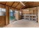 Interior view of plywood storage shed with built-in shelving and an open door to the backyard at 3030 E Shangri La Rd, Phoenix, AZ 85028