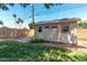 Backyard storage shed with ample room for storage, set amidst a well-maintained lawn and mature trees at 3030 E Shangri La Rd, Phoenix, AZ 85028