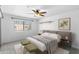 Bedroom with a plush bed, ceiling fan, and bright natural light from the large window at 3031 N Civic Center Plz # 317, Scottsdale, AZ 85251